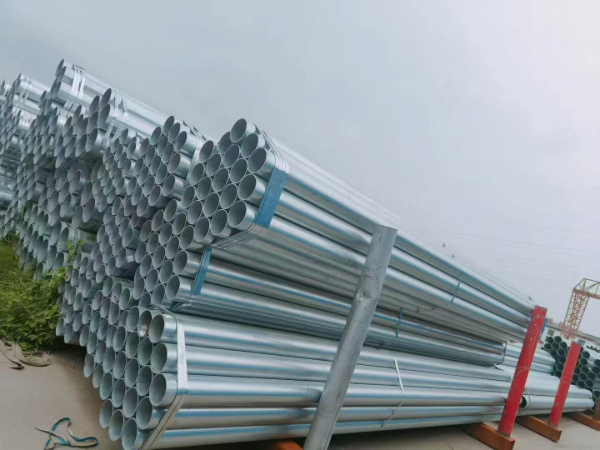 Galvanized seamless pipe cut end showing wall thickness and zinc layer